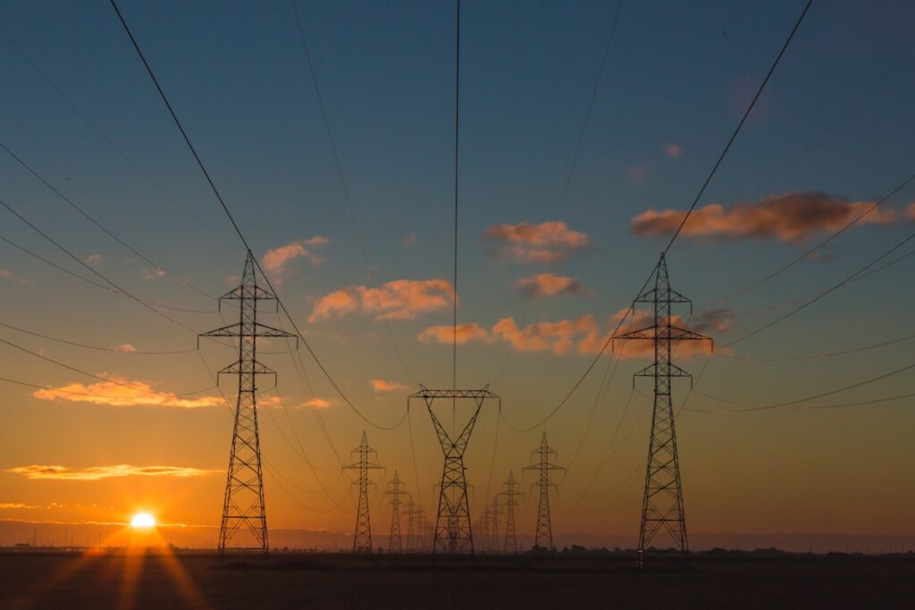 cheapest electricity texas - power transmission towers at sunset