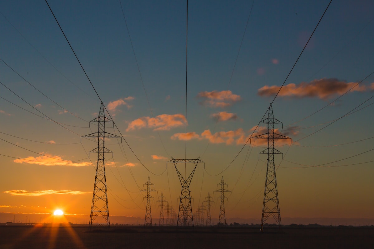 cheapest electricity texas - power transmission towers at sunset
